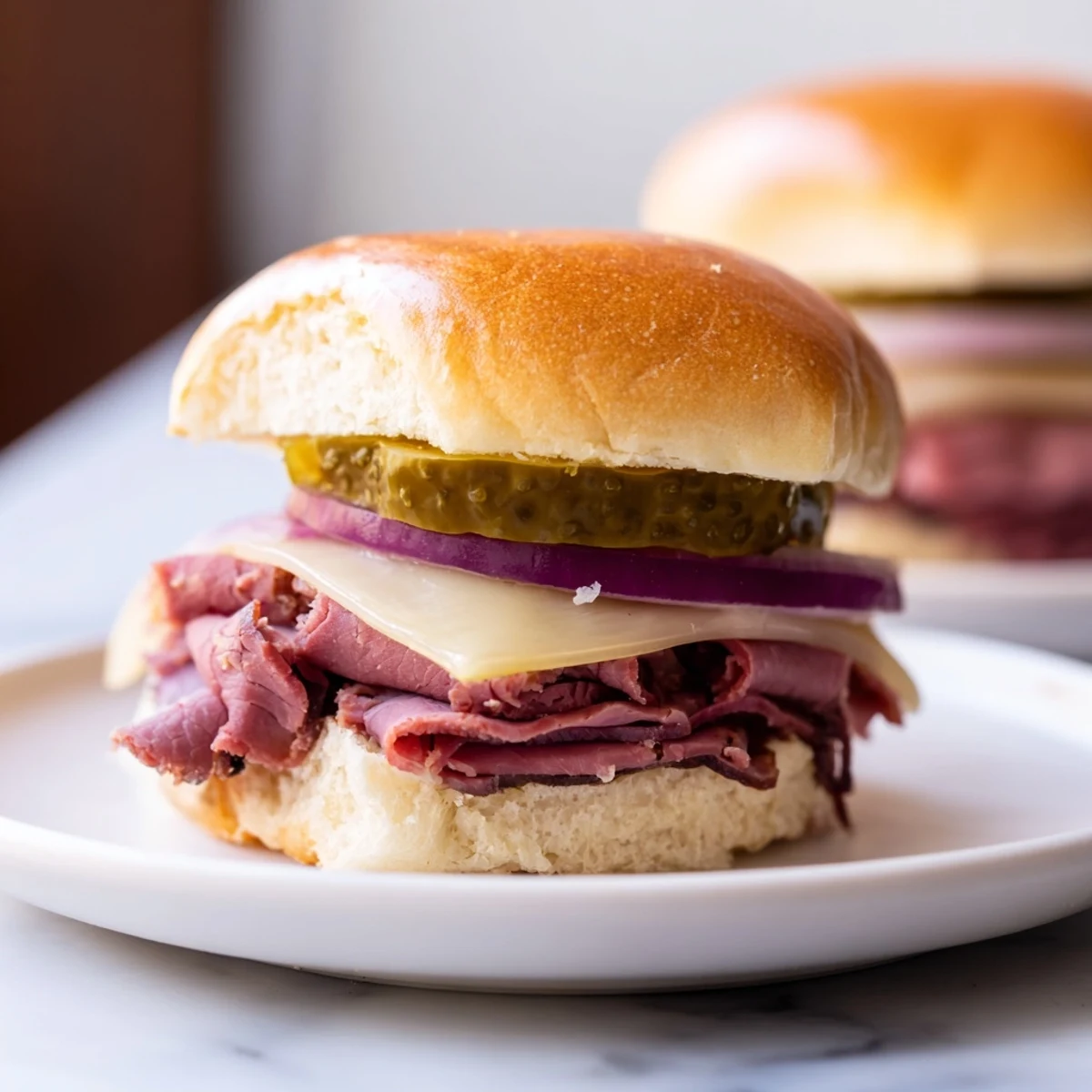 Freshly baked Corned Beef Sliders with mustard and Swiss cheese, served warm on a rustic wooden board.