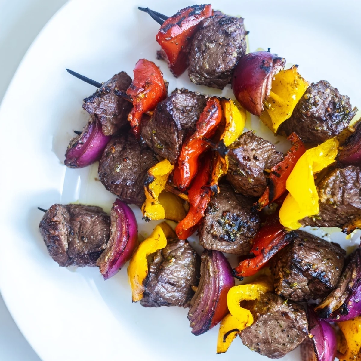 Tender Beef Kebabs with Bell Peppers and Onions served over rice, perfect for a Mediterranean-inspired dinner.