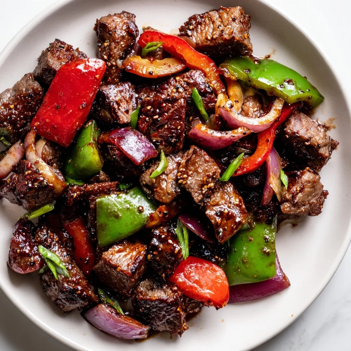 Freshly seared Vietnamese Shaking Beef rests on watercress with a zesty lime dipping sauce on the side.  