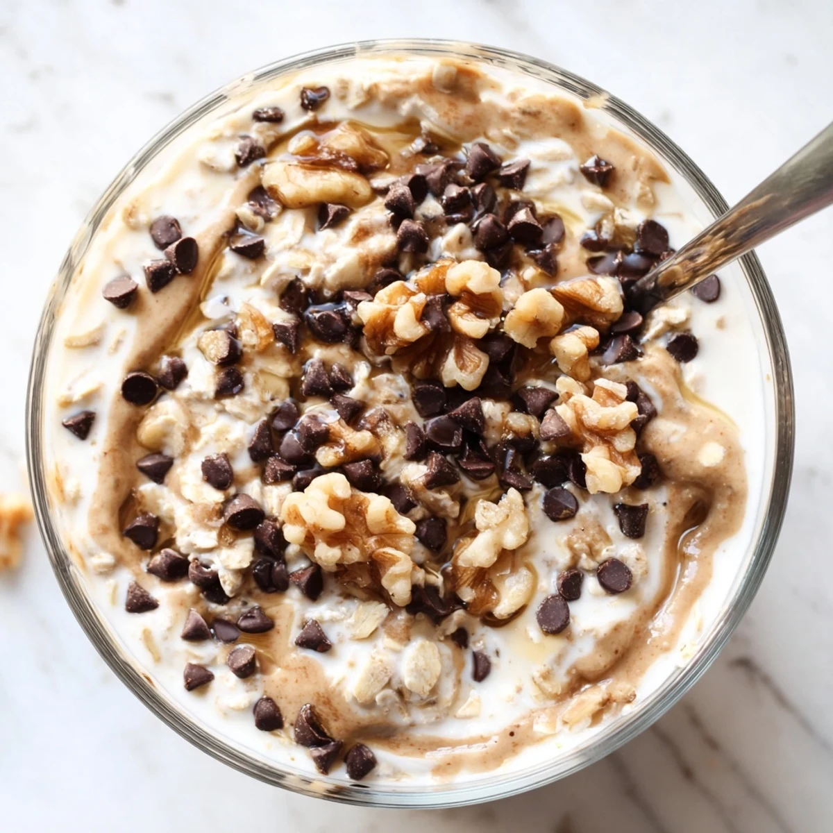 A jar of Cookie Dough Overnight Oats with creamy texture and chocolate chips ready for a morning serving.