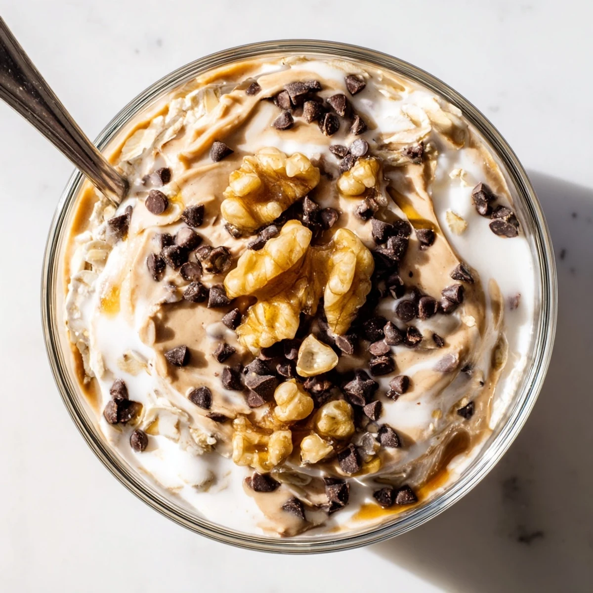 Visually impaired-friendly description: chilled Cookie Dough Overnight Oats with cinnamon aroma and spoon ready to eat.