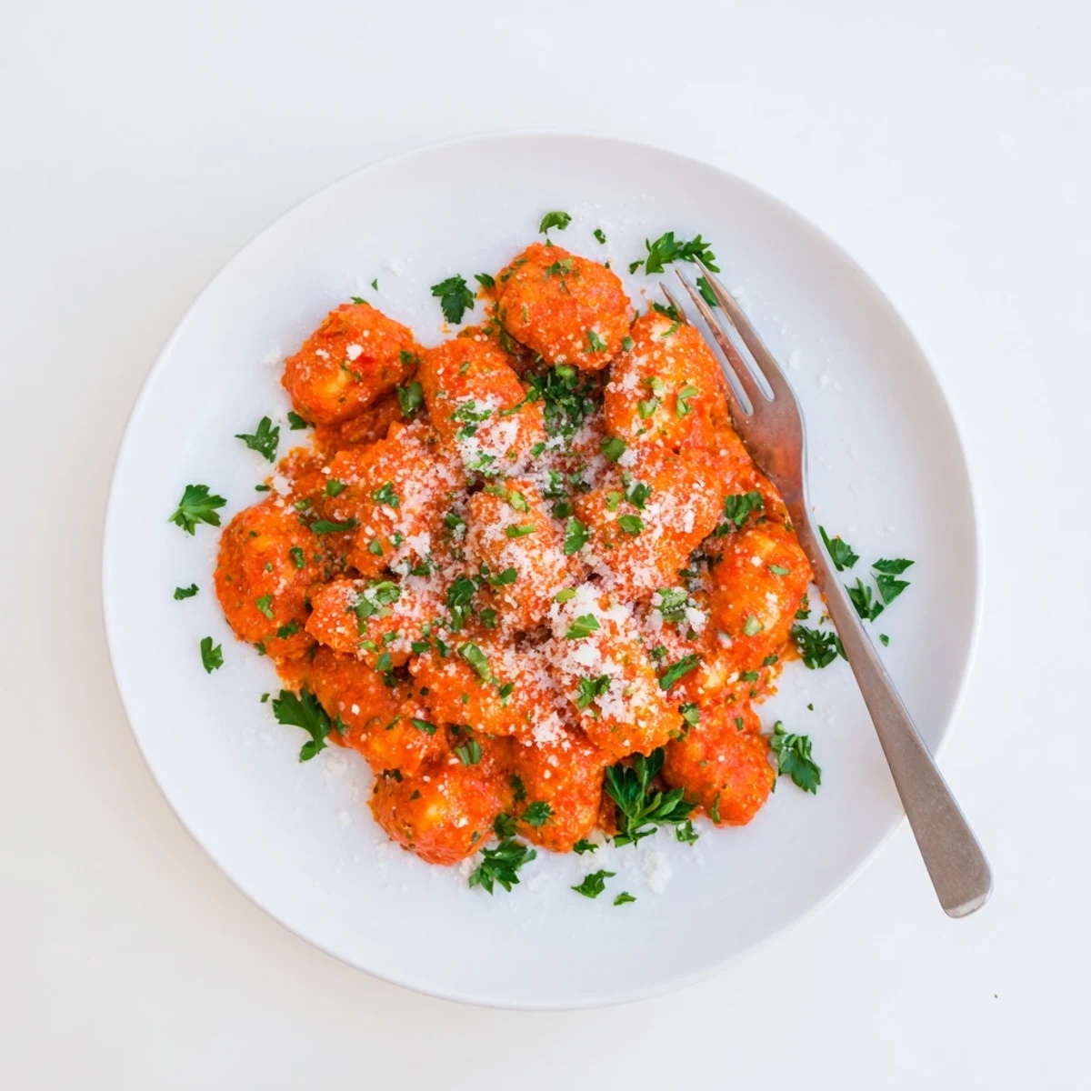 Close-up of gnocchi with quick romesco sauce, showing a smoky-sweet sauce coating each dumpling beautifully.