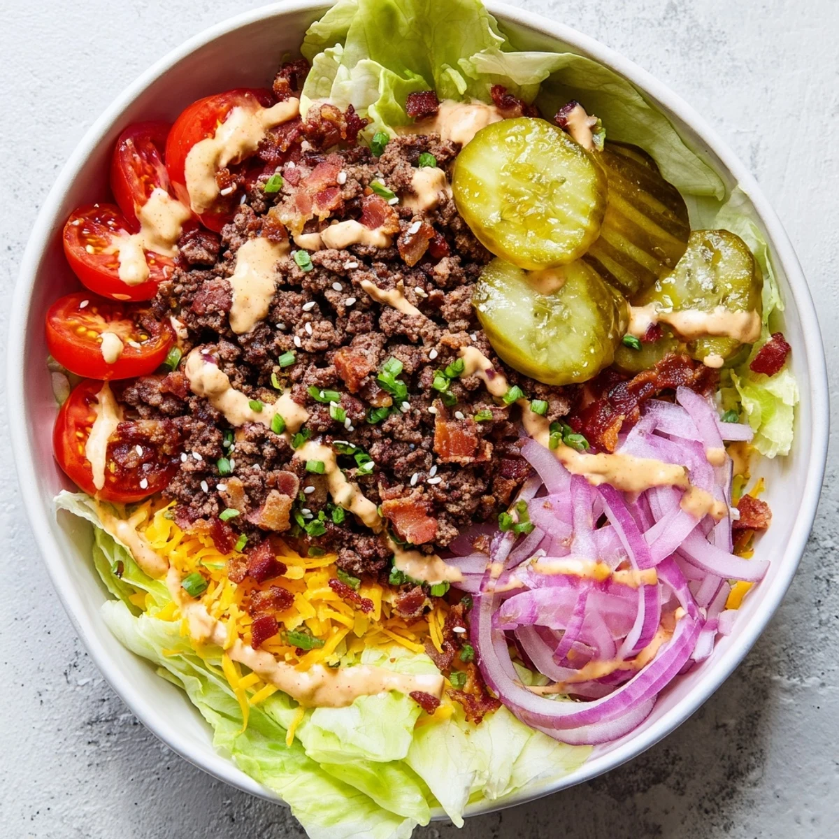 Deconstructed Smash Burger Bowl with beef, bacon, and tangy sauce served in a bowl.
