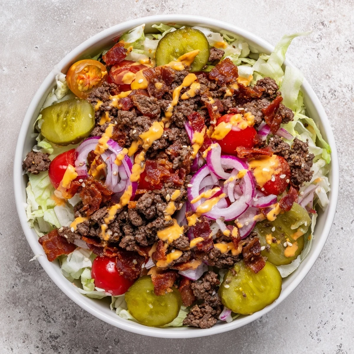 Fresh lettuce, tomatoes, and sesame seeds top this hearty Smash Burger Bowl for dinner.