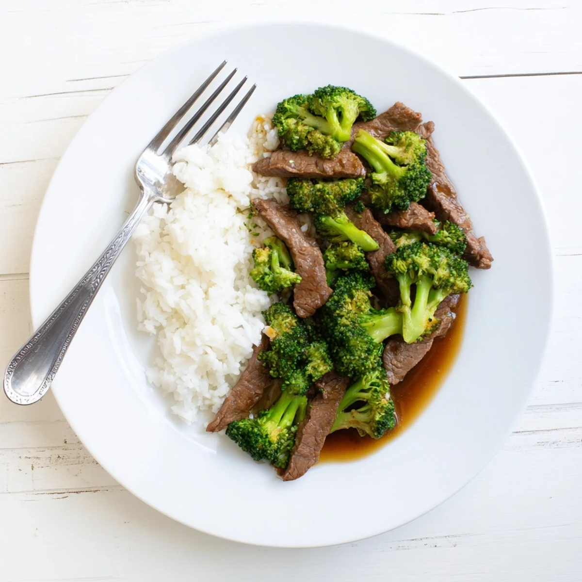 Tender beef and bright broccoli coated in a glossy, savory brown sauce for Better Than Takeout Beef With Broccoli.
