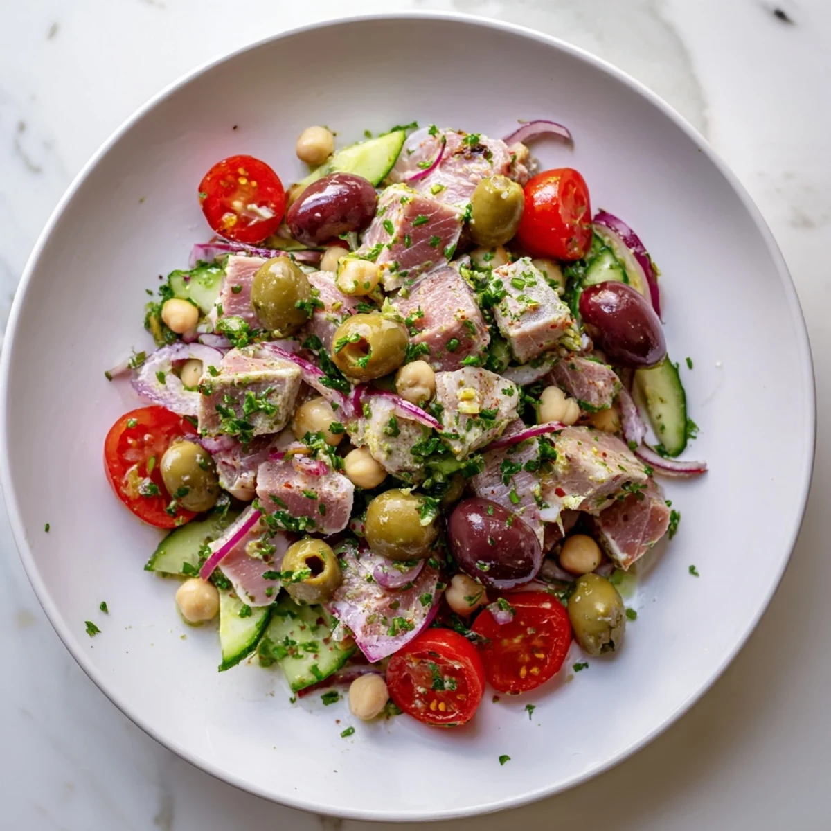 Protein-packed hearty tuna and garbanzo bean salad featuring olives parsley and tangy citrus dressing