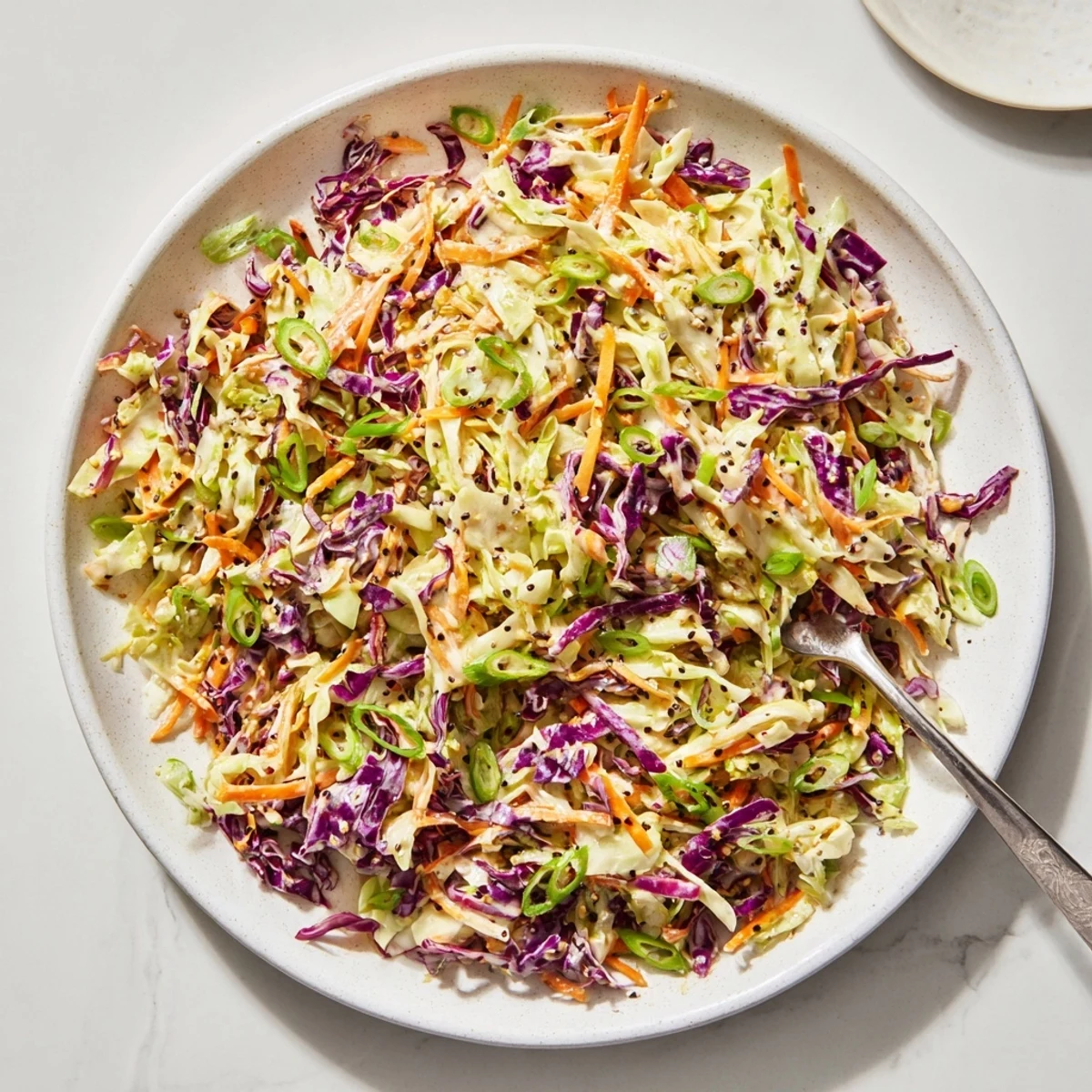 Crisp shredded cabbage and carrots coated in tangy easy creamy coleslaw dressing