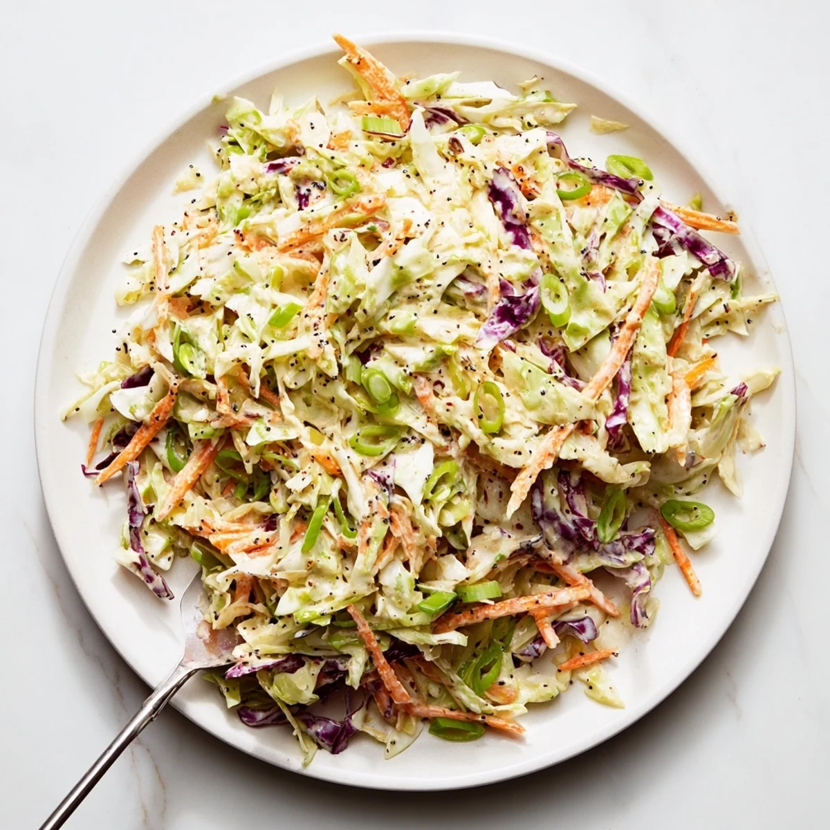Vibrant purple and green cabbage tossed with homemade easy creamy coleslaw sauce