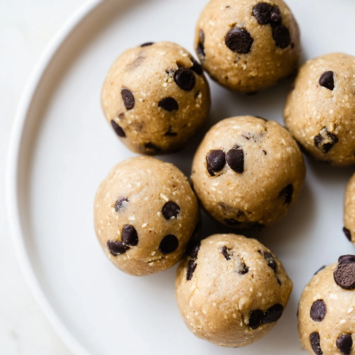 No-bake chocolate chip cookie dough protein balls studded with mini dark chocolate chips