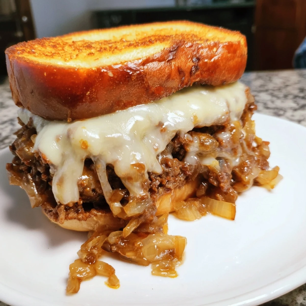 Hearty French onion sloppy joes piled high with savory beef and melted Gruyère cheese