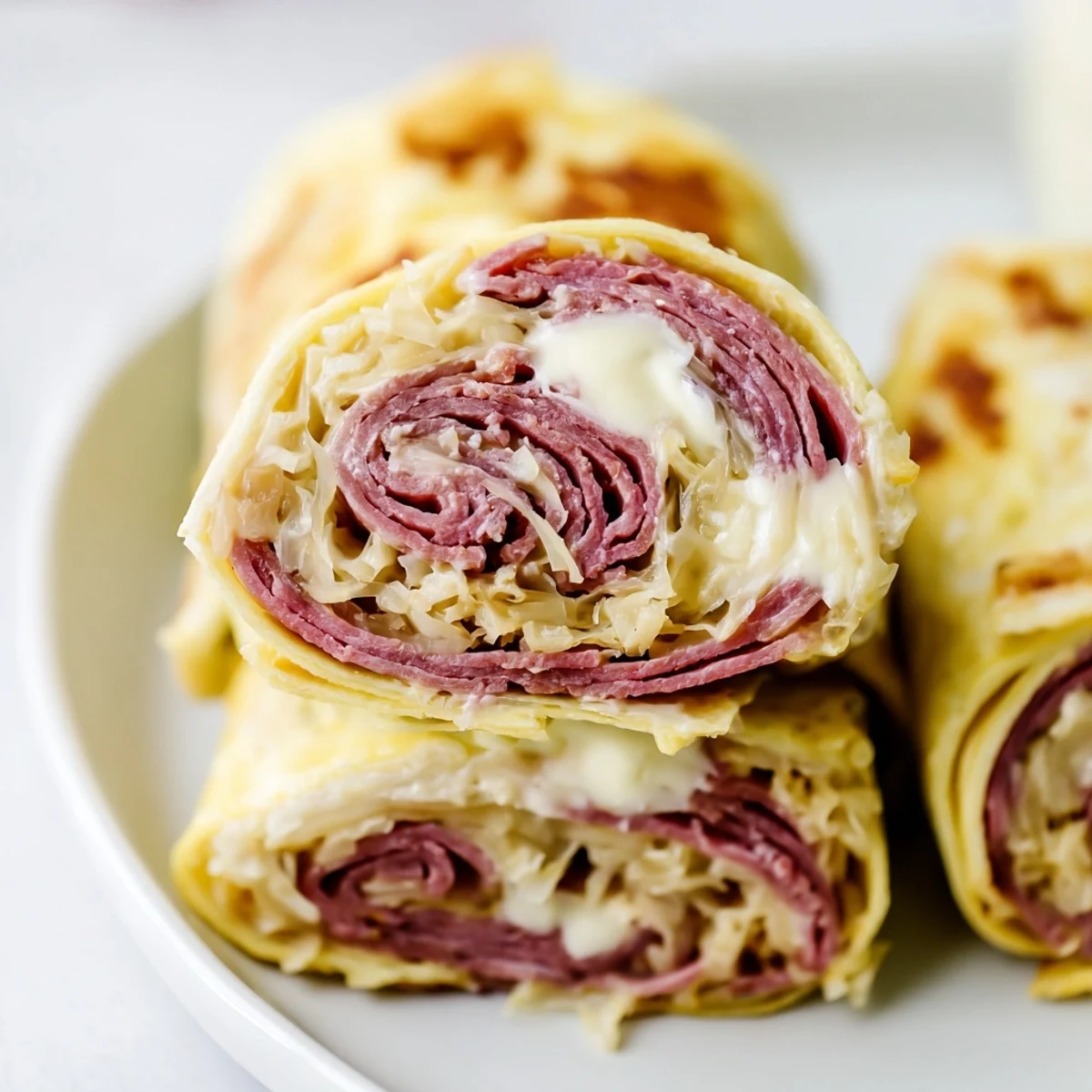 Savory Low Carb Reuben Egg Roll Ups wrapped around tender corned beef and creamy dressing
