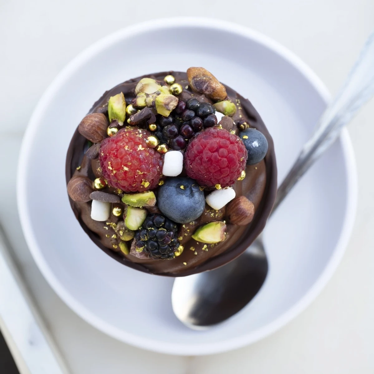Rich chocolate grazing cups topped with vibrant berries, crunchy nuts, and elegant chocolate curls