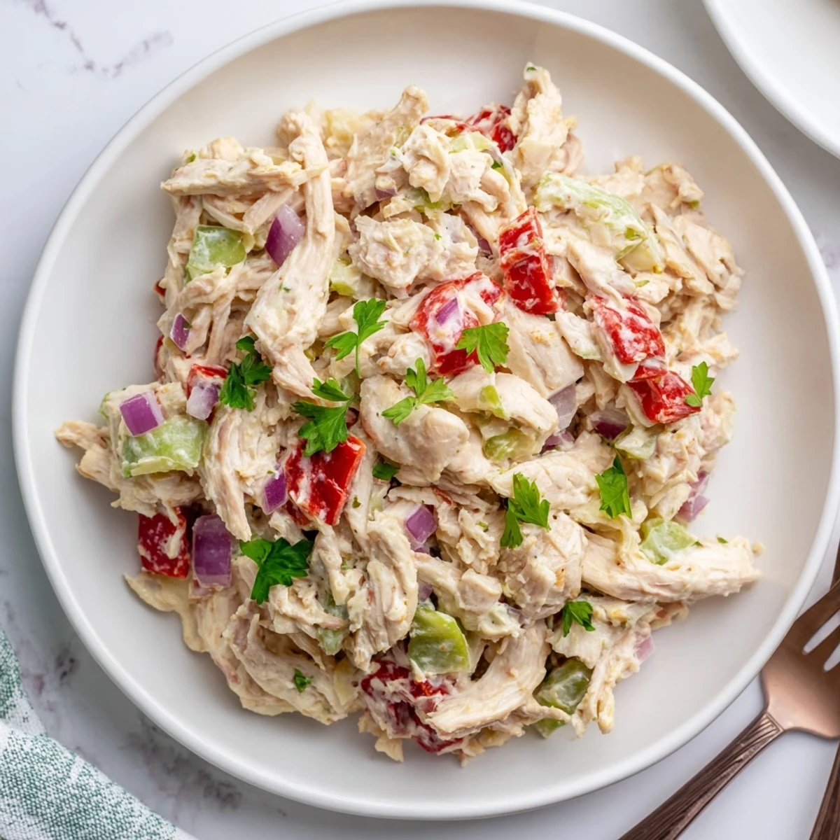 Chilled High Protein Pepperoncini Chicken Salad layered on mixed greens, zesty finish