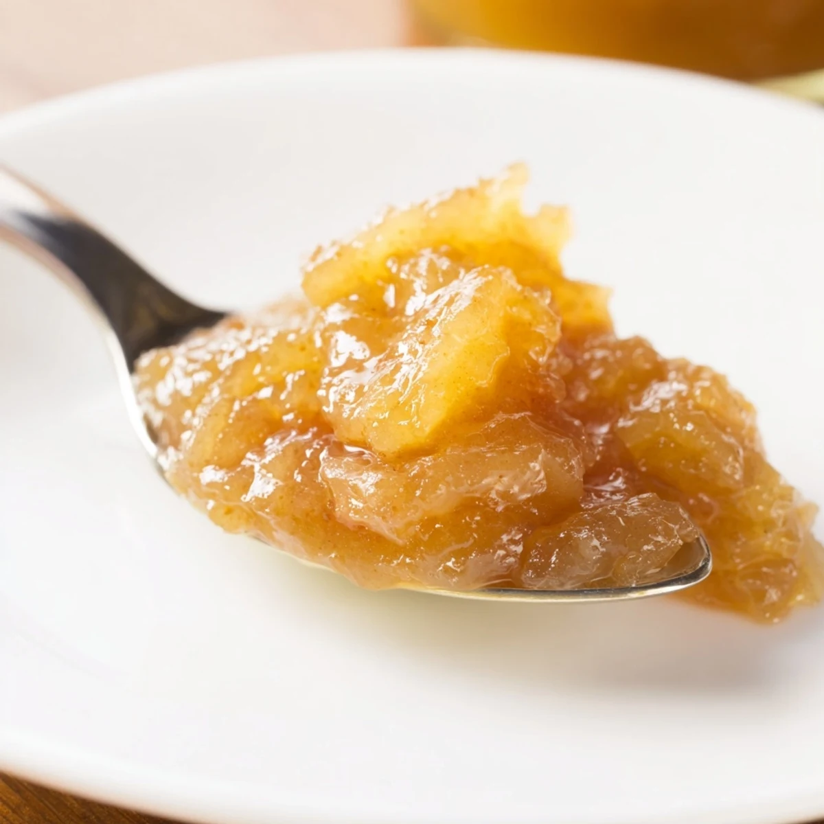 Jar of Fall Caramel Apple Jam with chunky apple bits, buttery aroma