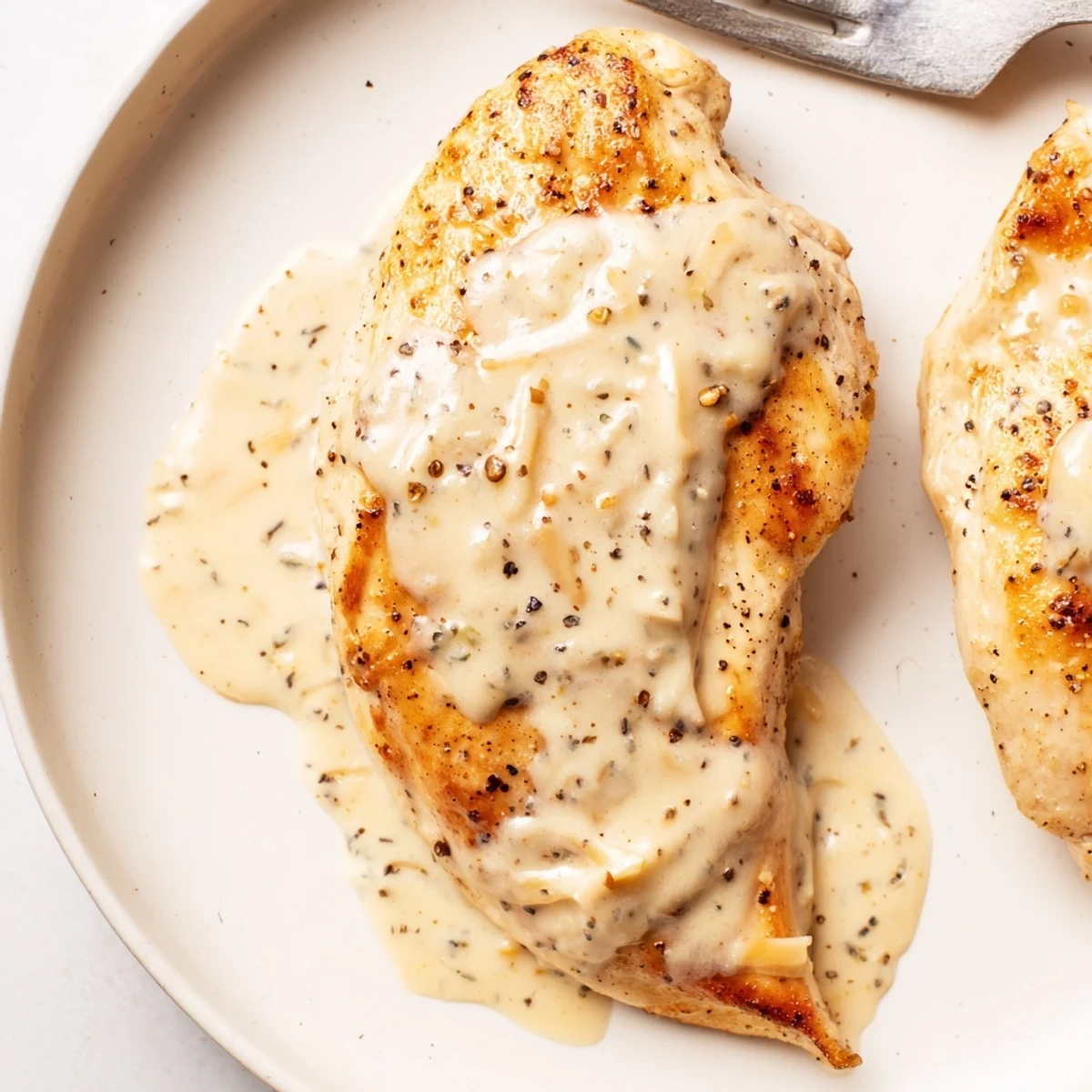 Weeknight Chicken With Cheese Sauce served over roasted vegetables for family comfort