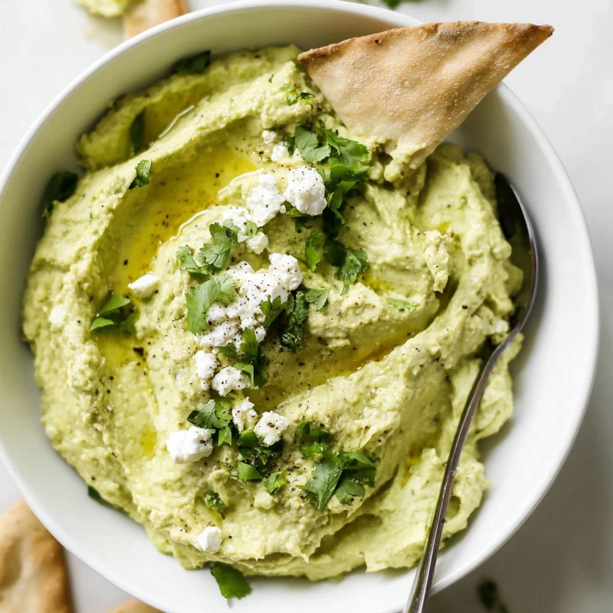 Smooth Creamy Avocado Feta Dip with lime brightness, pita chips nearby