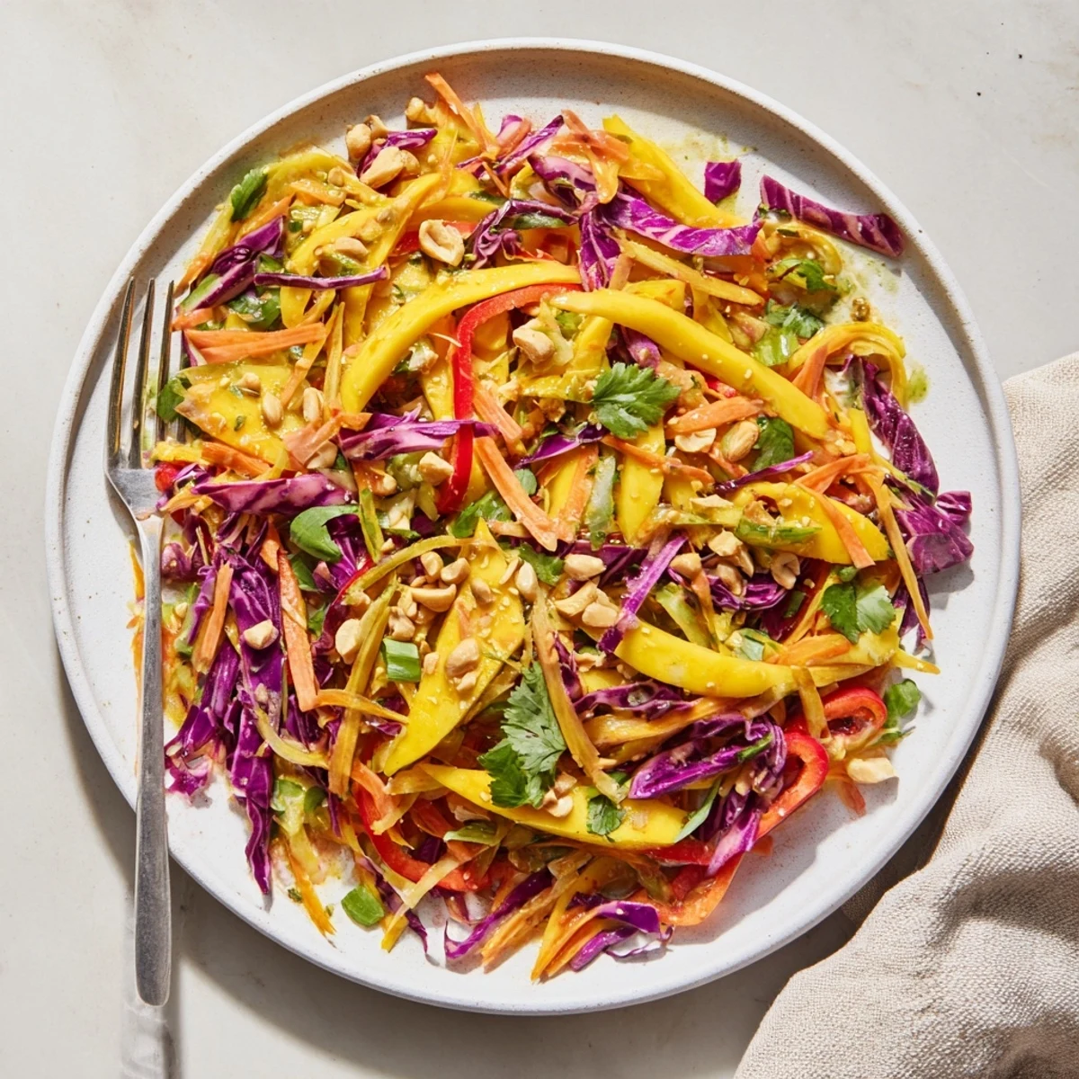 Colorful bowl of refreshing mango slaw with crisp carrots bell peppers and tangy lime dressing ready to serve