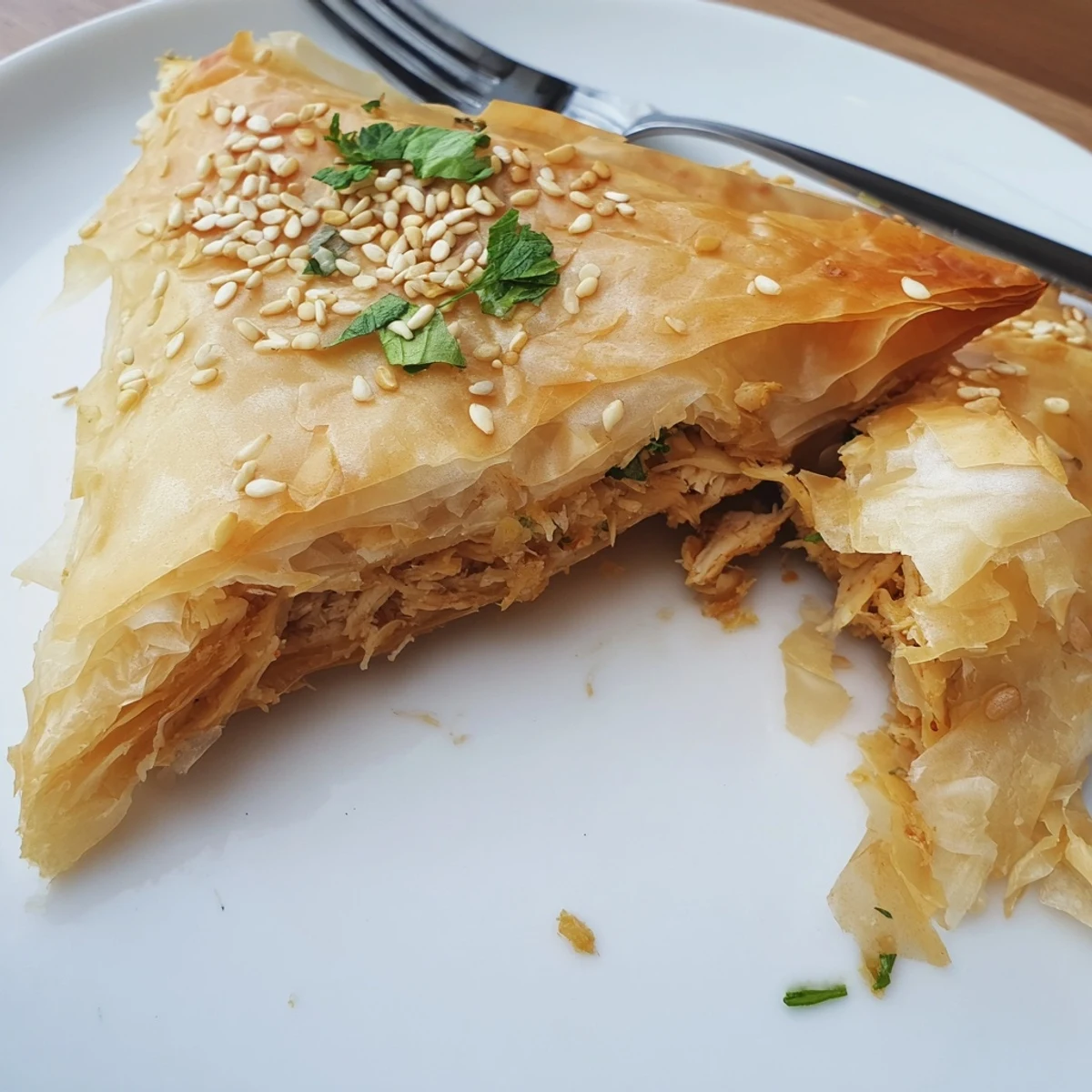 Golden brown Moroccan spiced chicken briouats with crispy phyllo pastry and aromatic herb filling