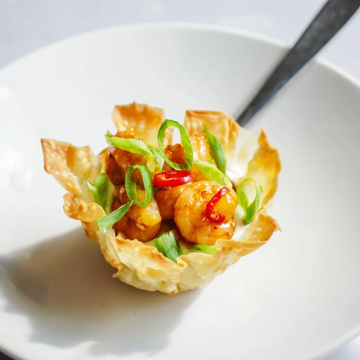 Golden, crunchy Crispy Shrimp Wonton Cups With Lime Cream, garnished with cilantro