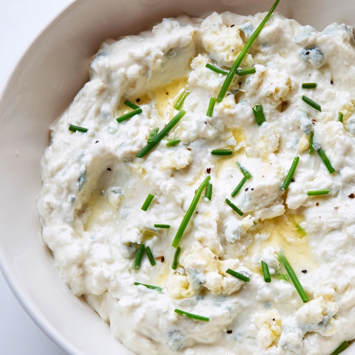 Velvety blue cheese dip served alongside buffalo wings and toasted baguette slices