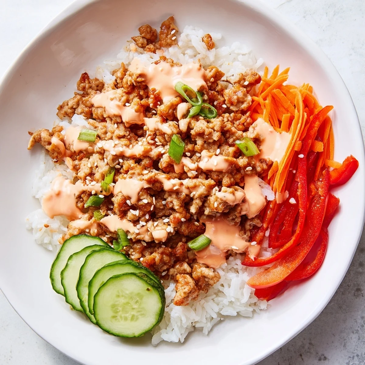 Ground Turkey Rice Bowls With Bang Bang Sauce drizzled over crisp veggies and fluffy white rice