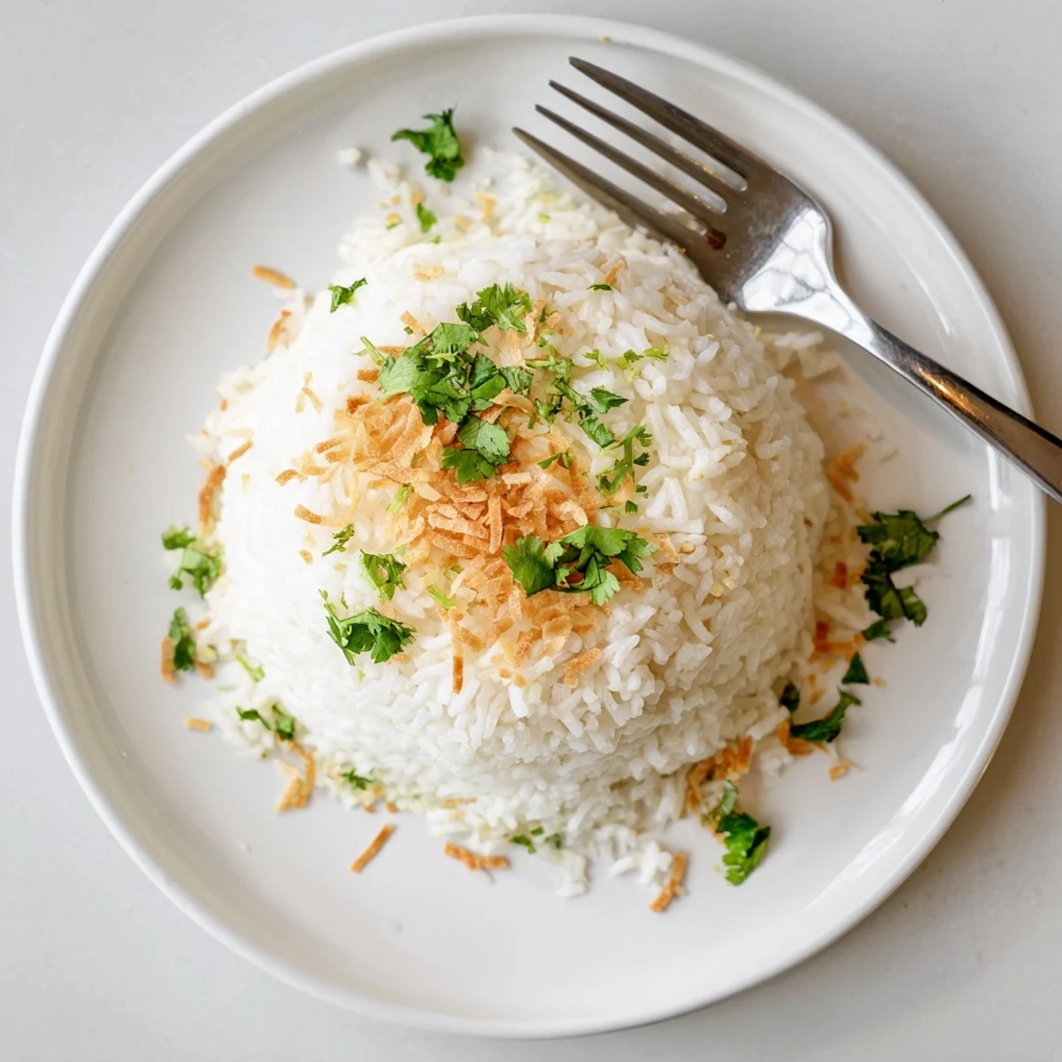 Creamy coconut rice served as a golden side dish alongside Thai curry