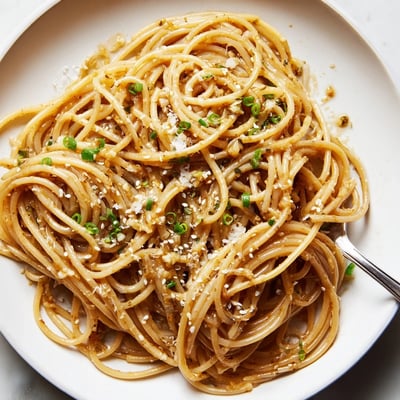 Savory Garlic Noodles served hot with noodles coated in a glossy, aromatic garlic butter sauce and Parmesan.